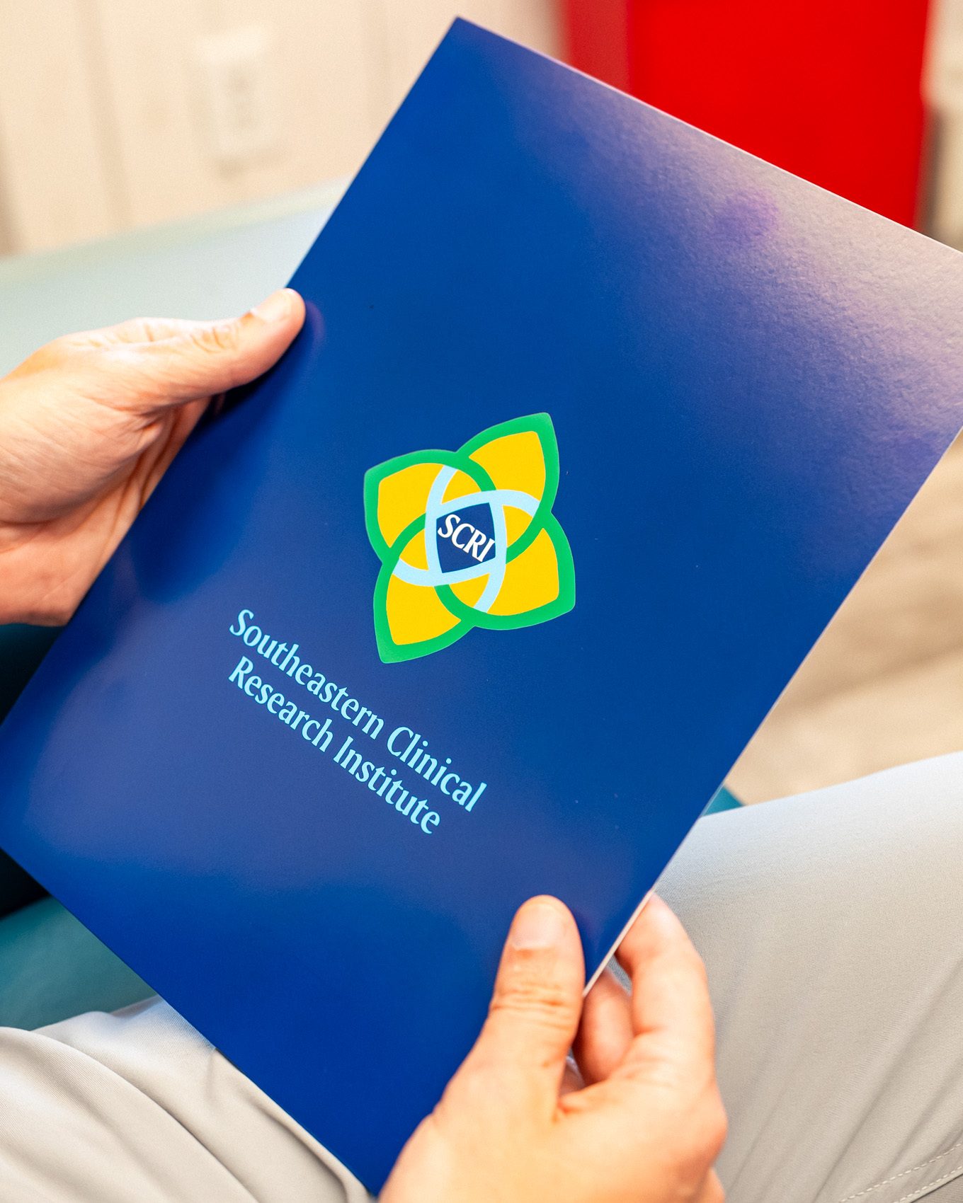A study folder handed between coordinator and physician