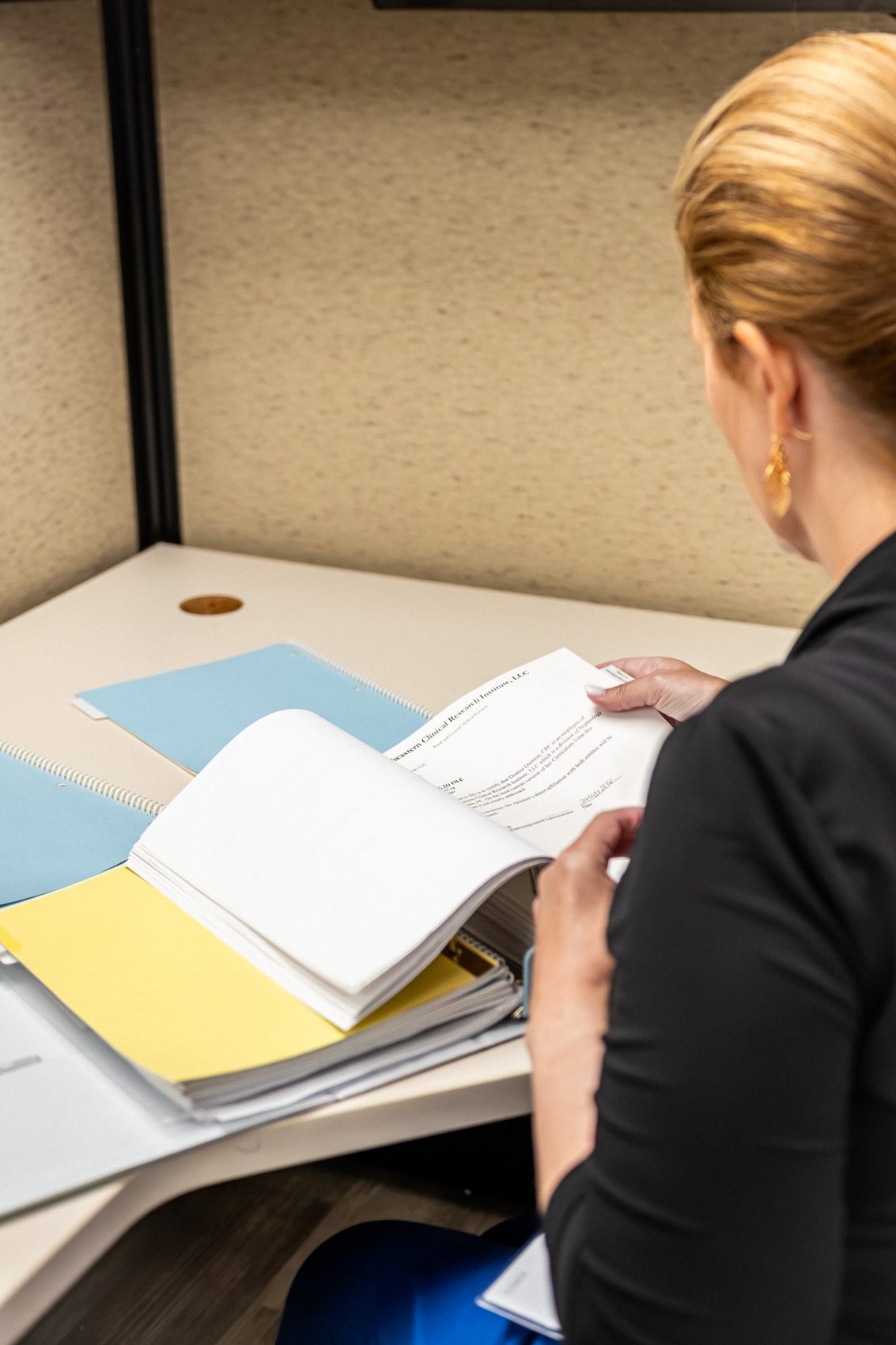 A certified clinical research coordinator with a study binder